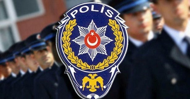 Male and female police officer standing in front of police car.